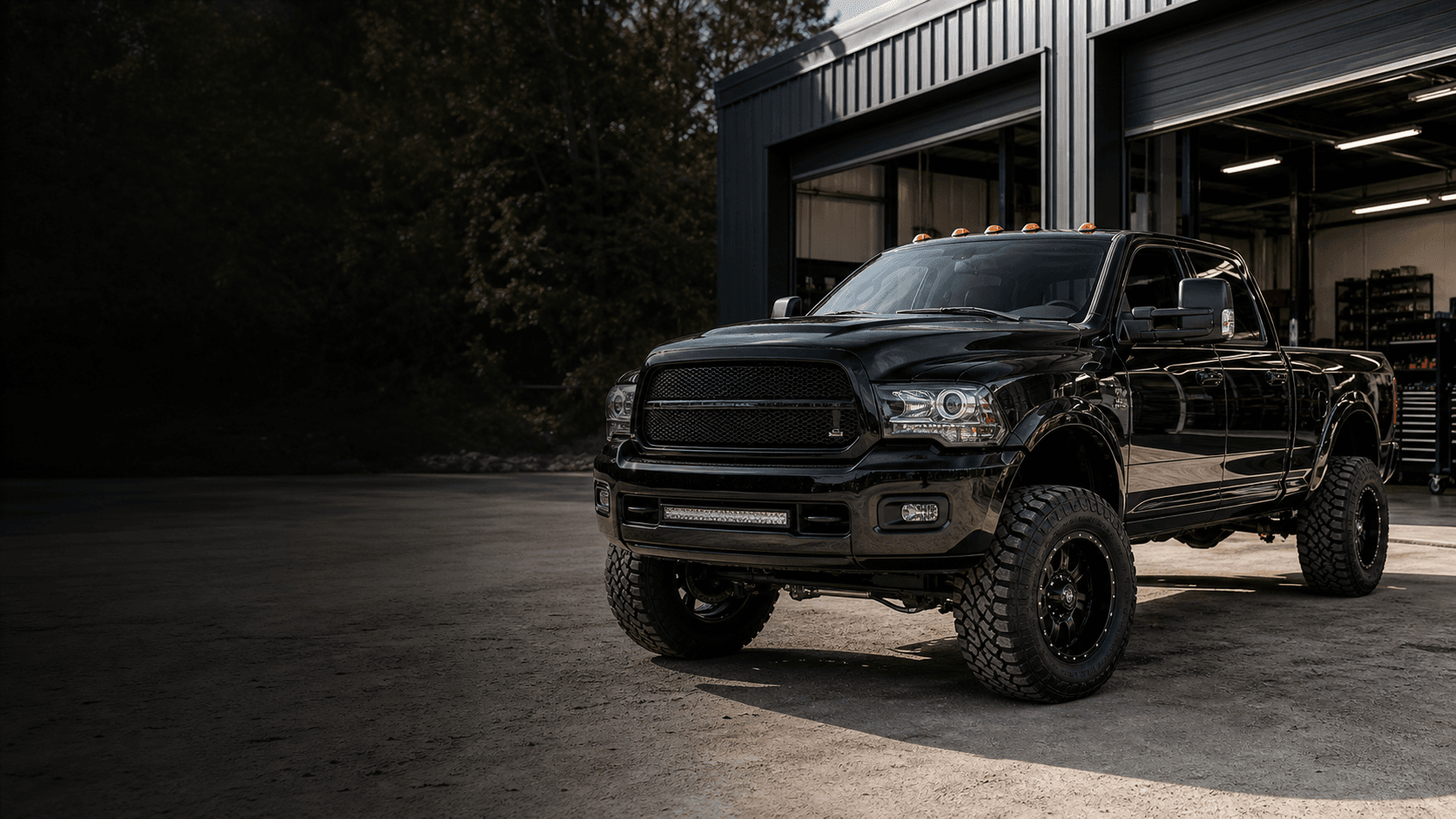 Modified diesel truck outside a workshop